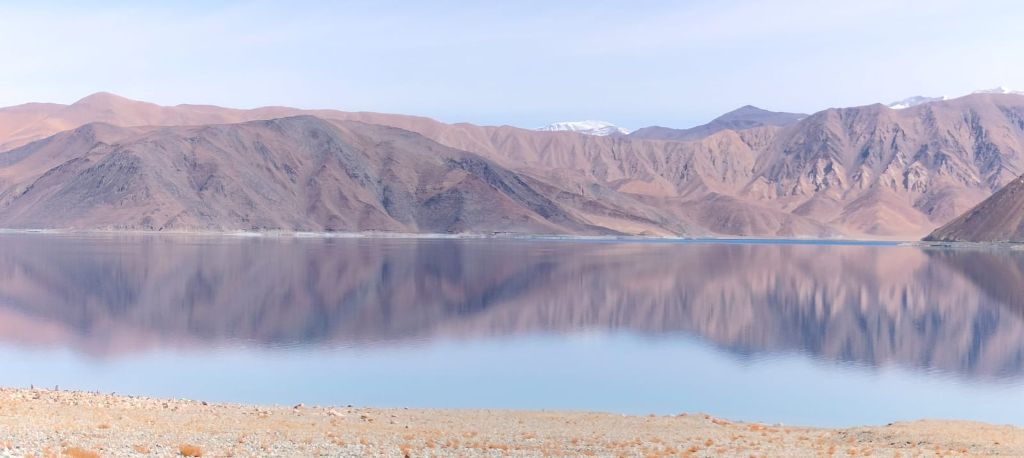 Mountain reflection in Pangong Lake at dawn